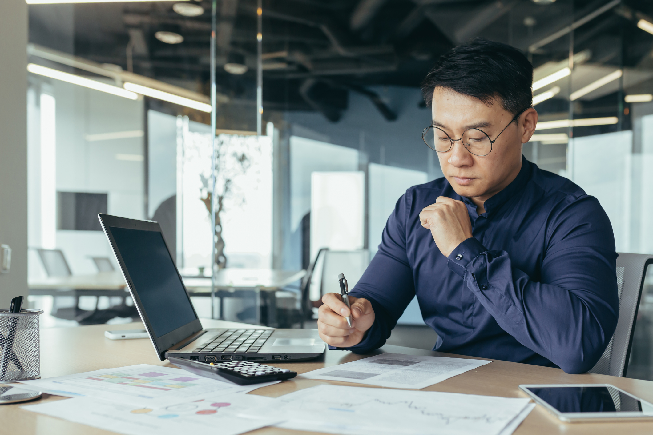 Business professional working on a laptop in an office environment