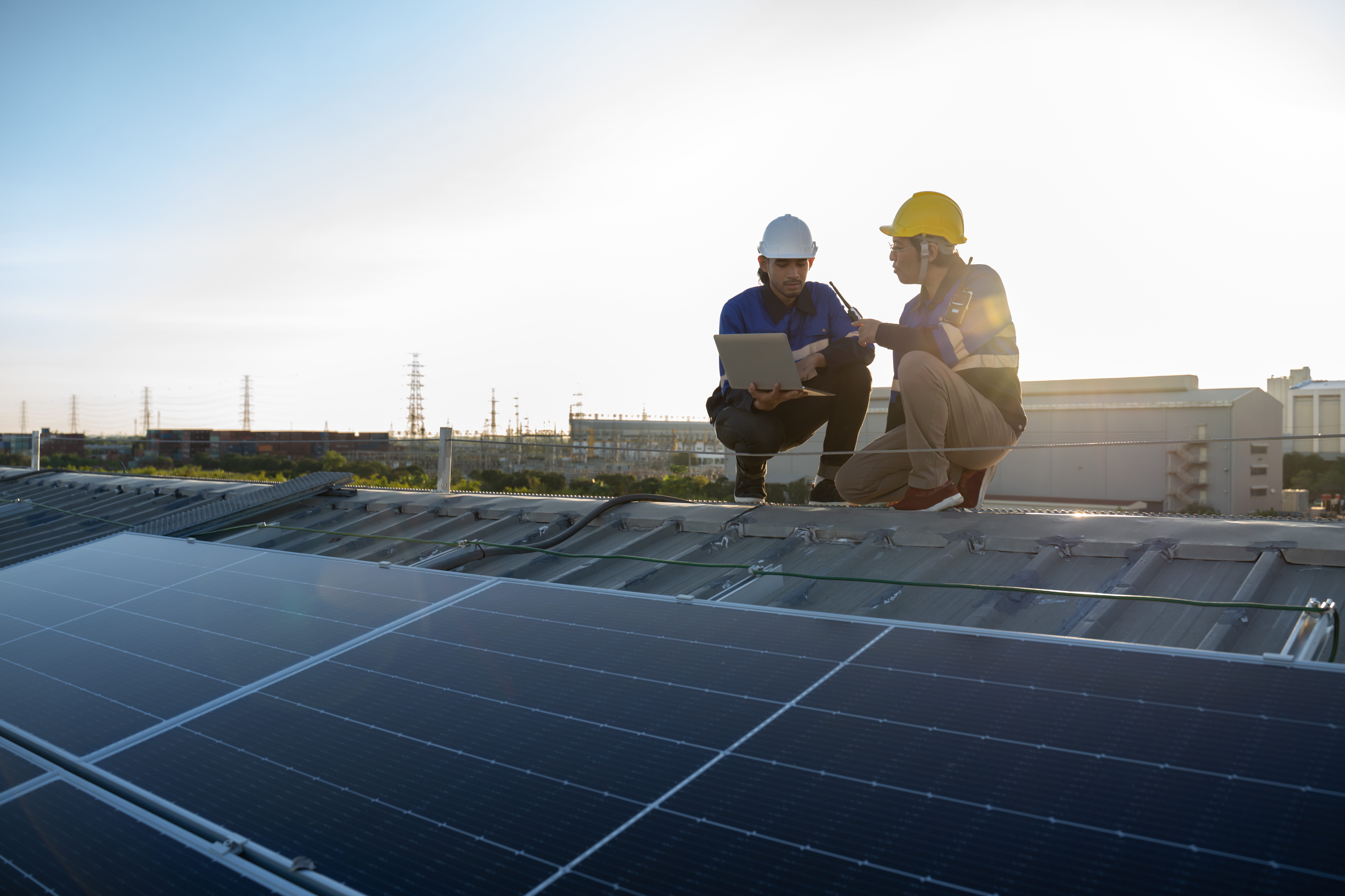 Engineers reviewing solar infrastructure as part of operational sustainability initiatives.